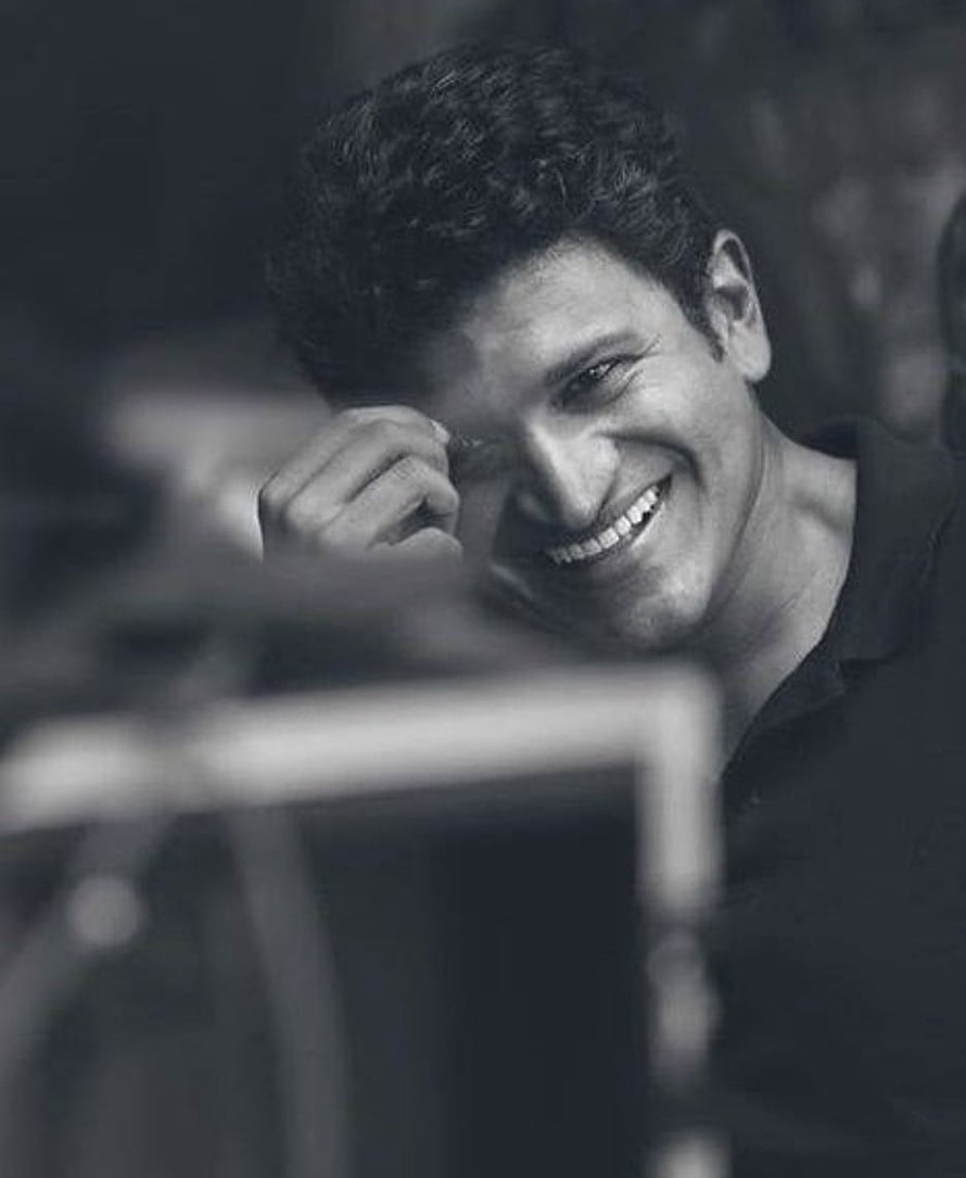 Punith Rajkumar smiling portrait in black and white with hand near face HD phone wallpaper