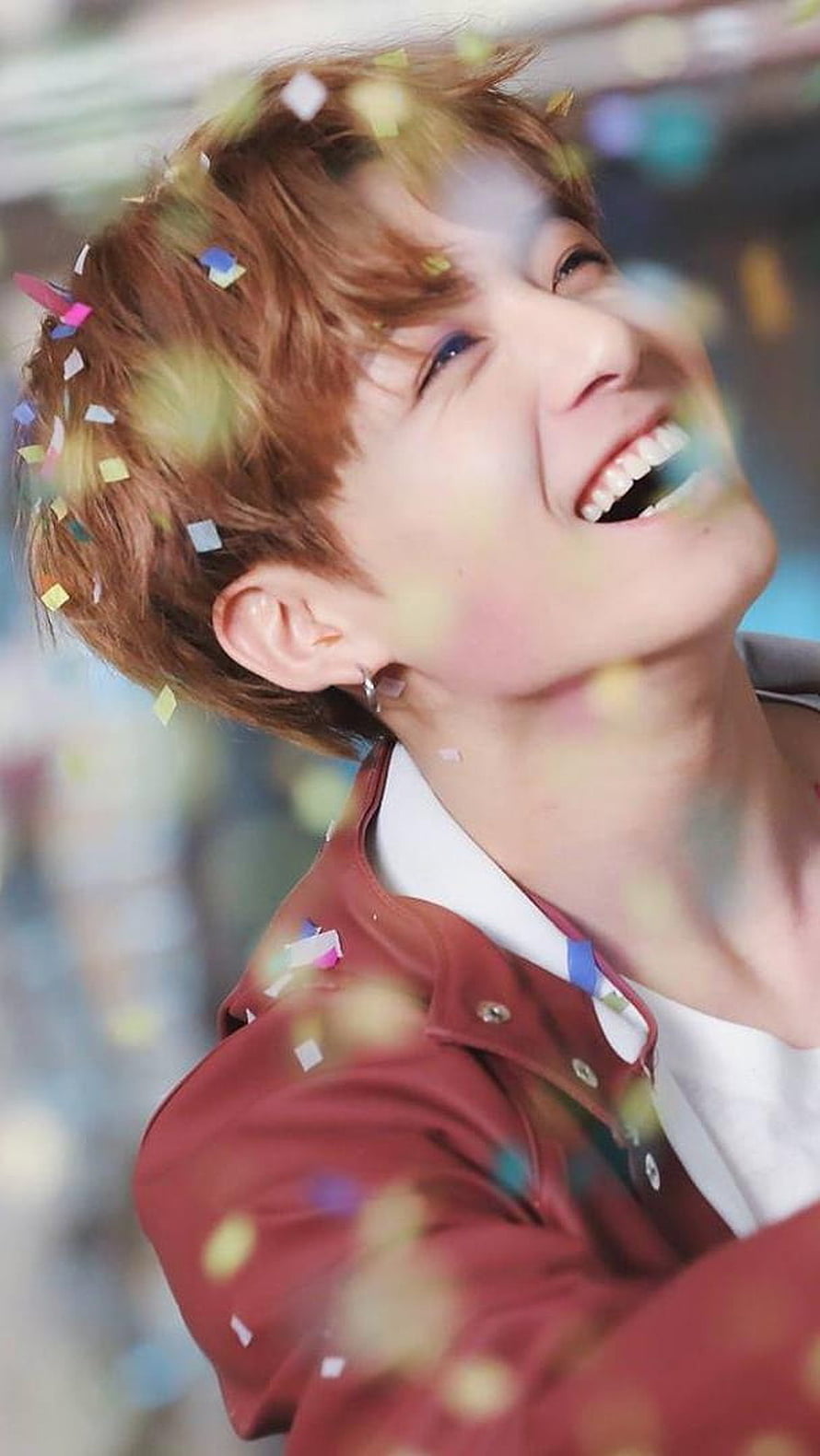 Jungkook BTS Smiling Under Falling Confetti in Red Jacket HD phone wallpaper