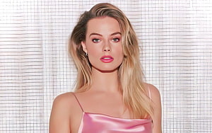 Margot Robbie in a pink satin dress with blonde hair against a white grid backdrop HD wallpaper