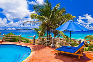 Tropical Poolside Retreat With Blue Umbrella And Ocean View HD wallpaper