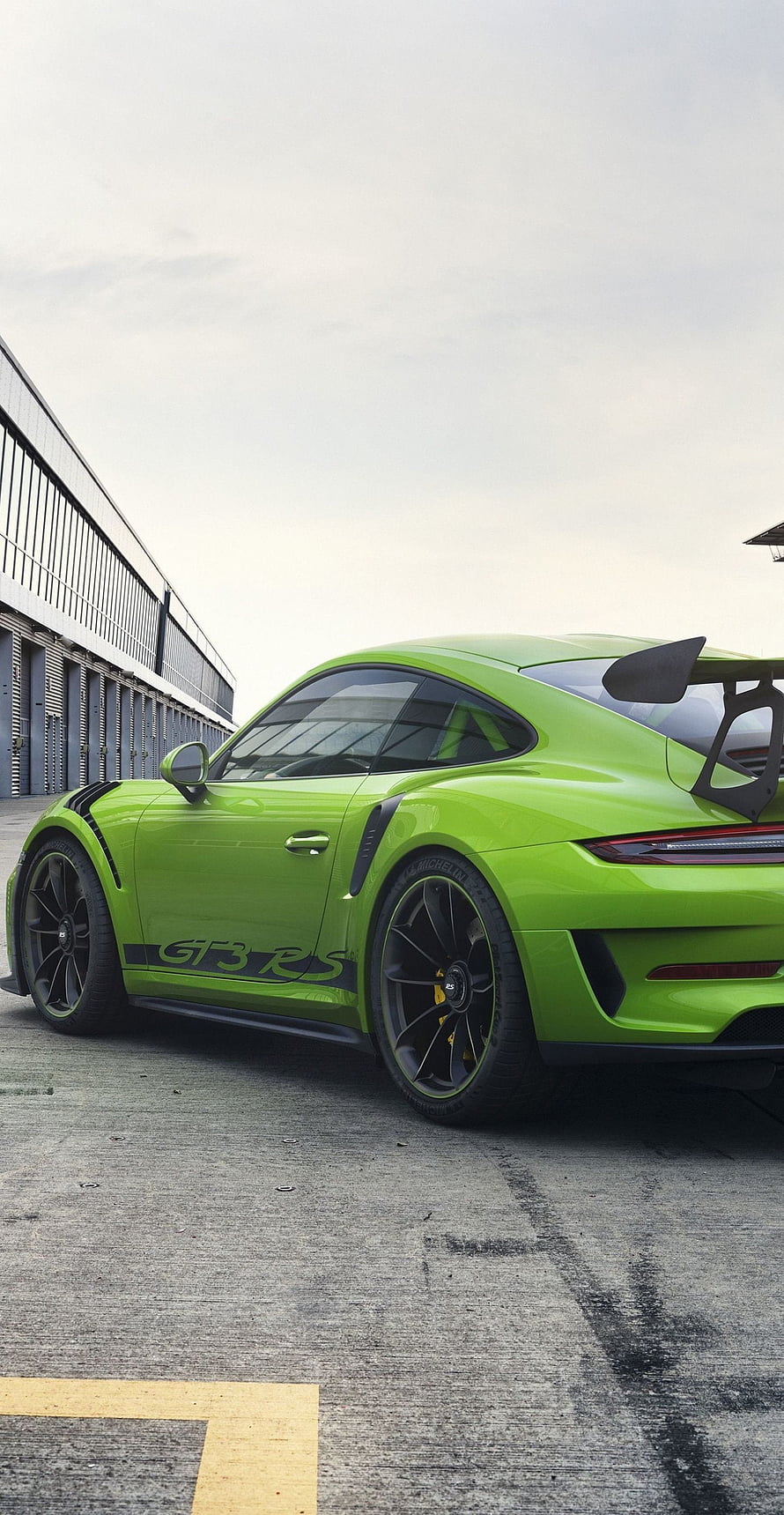 Lime Green Porsche 911 GT3 RS with Large Rear Wing Parked on Concrete HD phone wallpaper