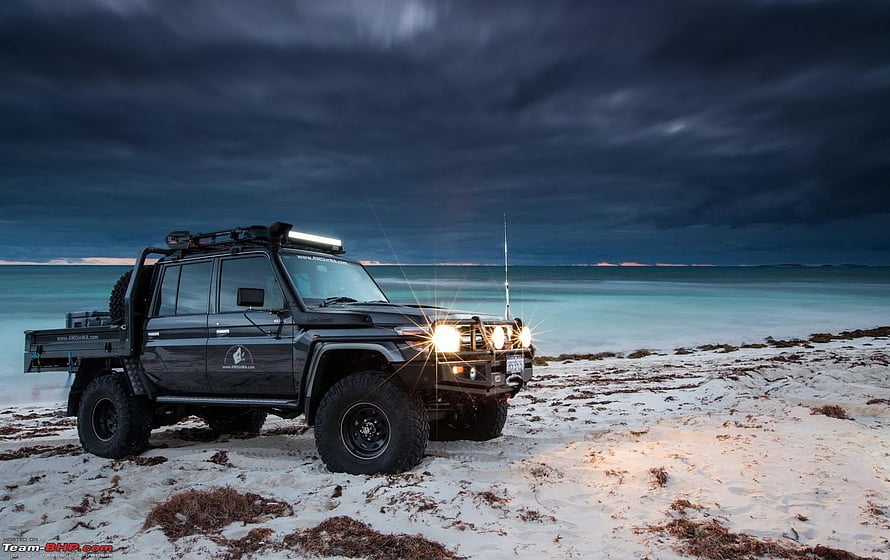 Black Toyota Land Cruiser 70 Series Pickup on a Stormy Beach at Dusk HD wallpaper