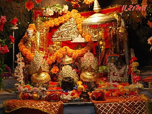 Sri Vaishno Devi Temple Shrine Decorated With Marigold Garlands And Gold Ornaments HD wallpaper