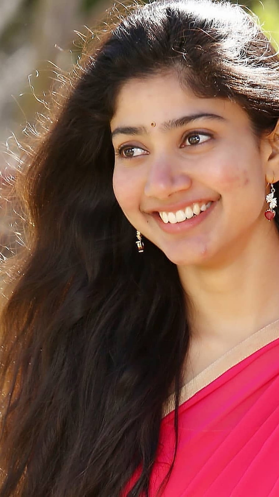 Sai Pallavi smiling portrait in a pink sari with long dark hair and gold earrings HD phone wallpaper