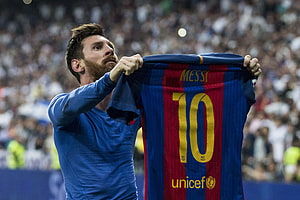 Lionel Messi holding up Barcelona jersey at Santiago Bernabeu stadium HD wallpaper