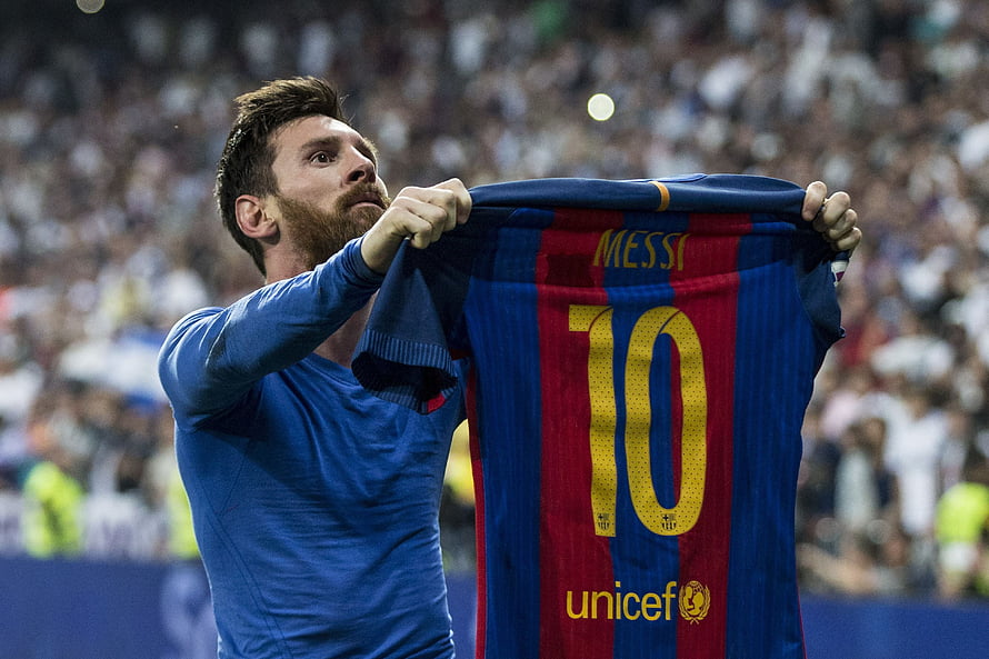Lionel Messi holding up Barcelona jersey at Santiago Bernabeu stadium HD wallpaper
