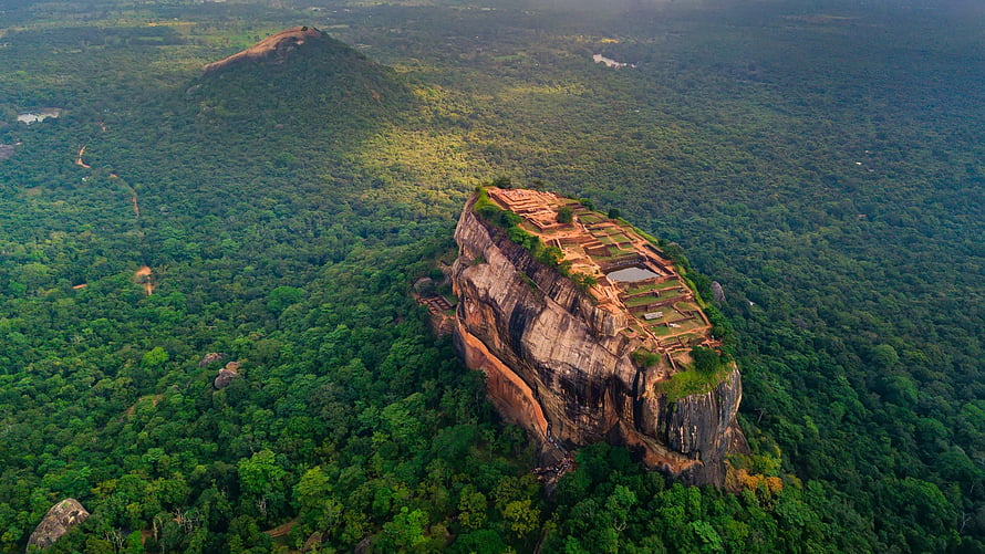 Aerial View of Sigiriya Rock Fortress Rising Above Lush Sri Lankan Jungle Canopy HD wallpaper