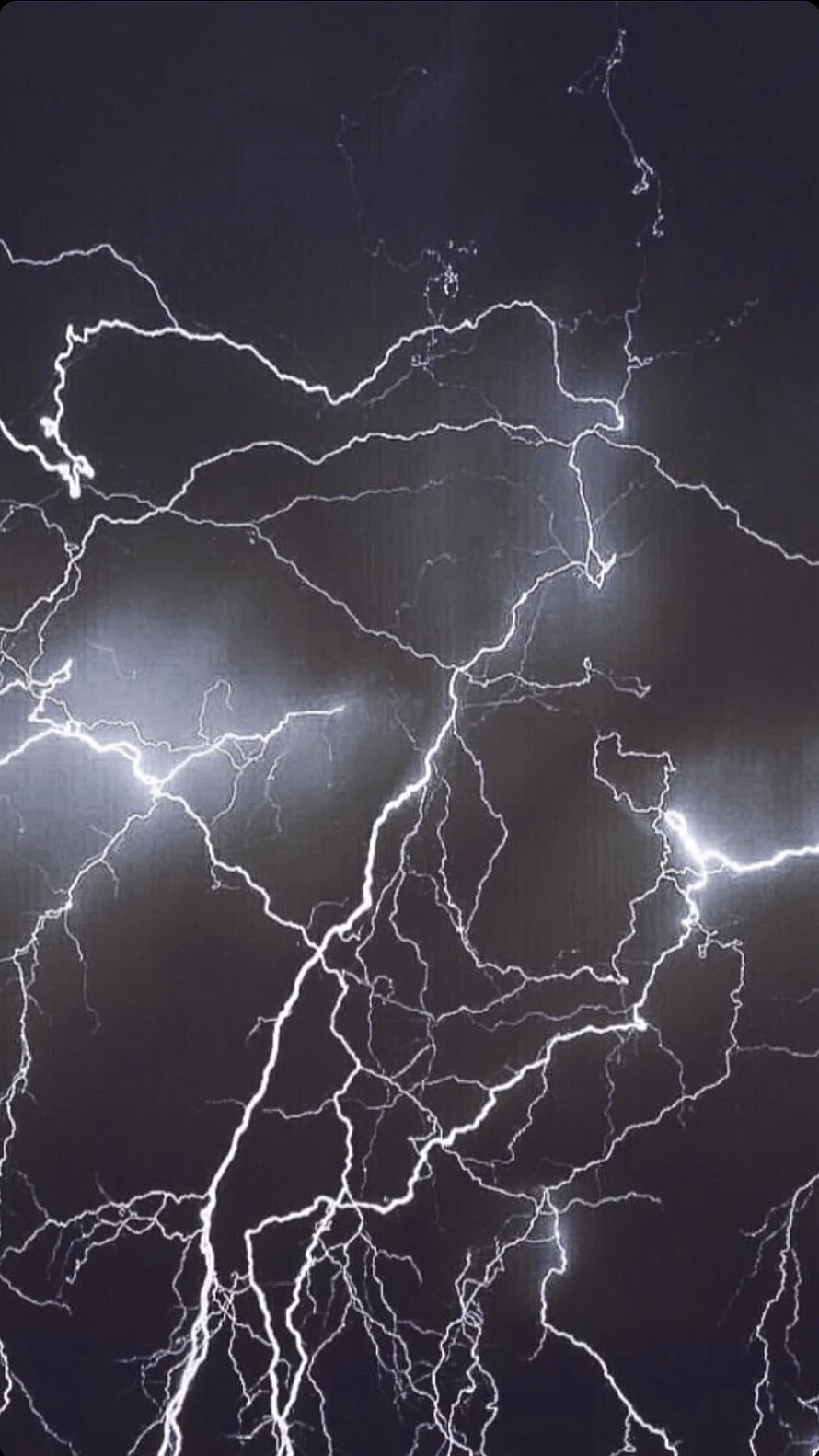 Dramatic branching lightning bolts striking through a dark stormy night sky HD phone wallpaper