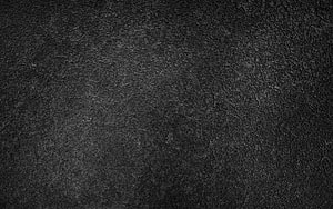 Dark Concrete Surface Texture with Rough Cement Grain and Subtle Lighting HD wallpaper