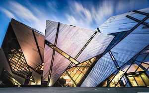 Angular Modern Architecture Facade with Geometric Metal Panels and Glass at Dusk HD wallpaper