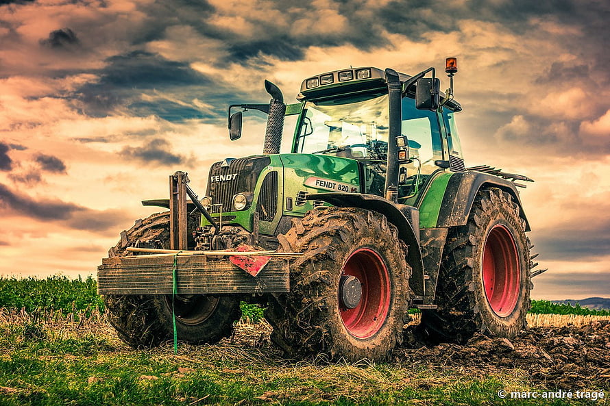 Fendt 820 Tractor in a Field Under Dramatic Sunset Sky HD wallpaper