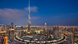 Burj Khalifa and Dubai Cityscape at Dusk with Illuminated Skyscrapers and Fountains HD wallpaper