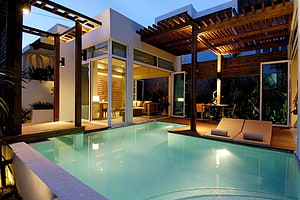 Modern Tropical Villa with Illuminated Swimming Pool and Wooden Pergola at Dusk HD wallpaper