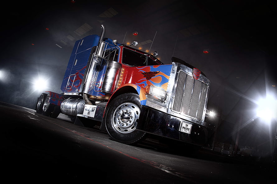 Optimus Prime Semi Truck with Custom Paint Job and Chrome Details in Dramatic Night Lighting HD wallpaper