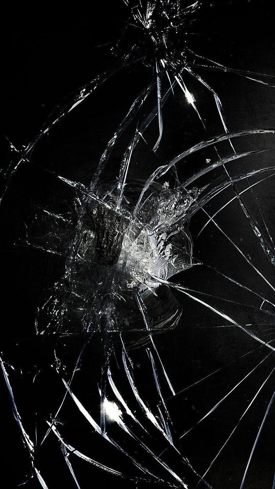 Shattered Glass Texture with Radiating Cracks on a Dark Background HD phone wallpaper