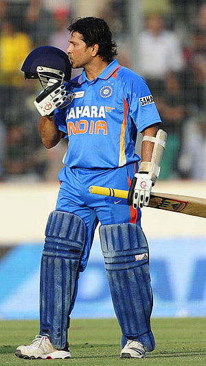 Sachin Tendulkar in India Cricket Kit Holding Bat and Helmet on the Field HD phone wallpaper