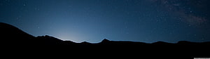 Starry Night Sky Over Mountain Silhouette With Faint Milky Way Glow HD wallpaper