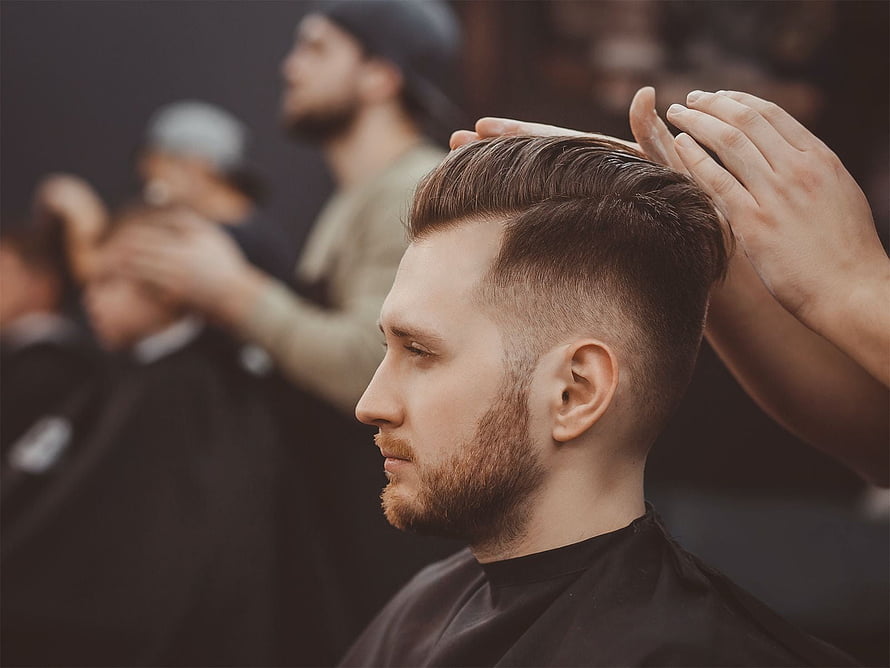 Modern Men's Side Part Fade with Beard in Barbershop Setting HD wallpaper