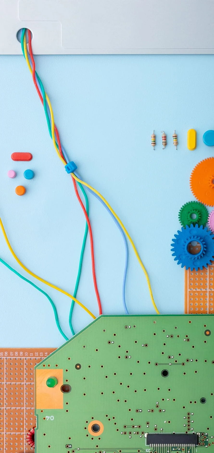 Colorful Circuit Board and Wires on Light Blue Background HD phone wallpaper