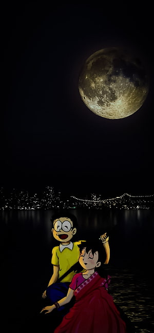 Nobita and Shizuka gazing at a full moon over a city skyline at night HD phone wallpaper