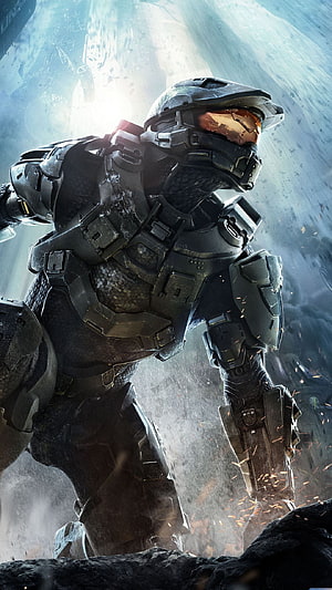 Master Chief in battle-worn armor standing in a dusty battlefield with sparks and dramatic backlight HD phone wallpaper