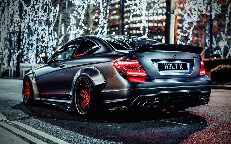 Modified Mercedes-Benz C63 AMG W204 with Widebody Kit and Red Rims at Night HD wallpaper
