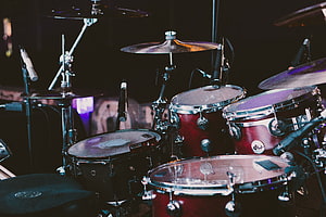 Professional DW Drum Kit with Cymbals and Microphones on a Dark Stage HD wallpaper