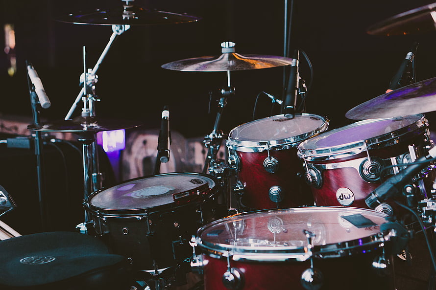 Professional DW Drum Kit with Cymbals and Microphones on a Dark Stage HD wallpaper