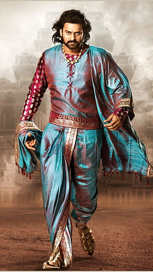 Prabhas as Baahubali in ornate teal and maroon royal costume with palace backdrop HD phone wallpaper