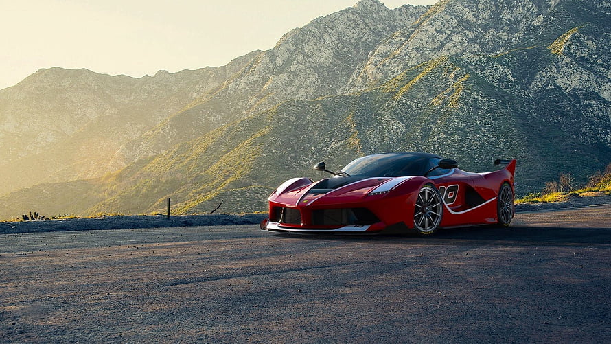Red Ferrari Super Car Parked On Mountain Road At Sunset HD wallpaper