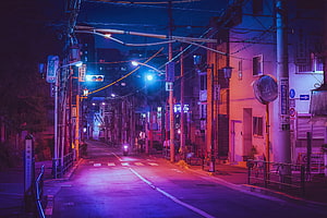 Neon-lit Japanese street at night with purple and blue ambient lighting HD wallpaper