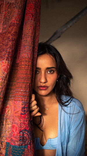 Neha Sharma Portrait Behind Red Patterned Curtain in Blue Linen HD phone wallpaper