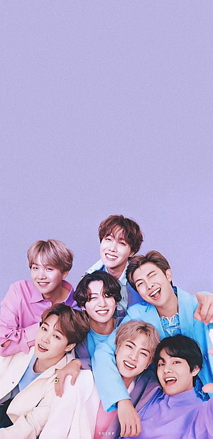 BTS Members Smiling Together in Pastel Outfits Against a Soft Lavender Background HD phone wallpaper
