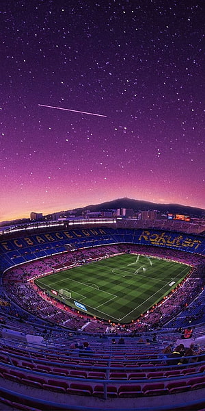 Camp Nou Stadium Under a Starry Night Sky with Shooting Star and City Skyline HD phone wallpaper