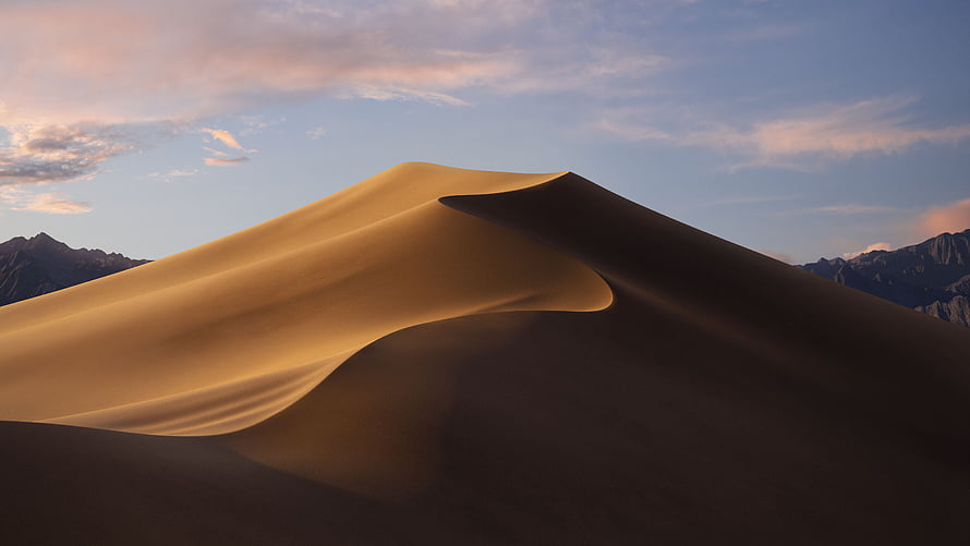 Golden Sand Dune Ridge at Sunset with Distant Mountain Range and Soft Clouds HD wallpaper