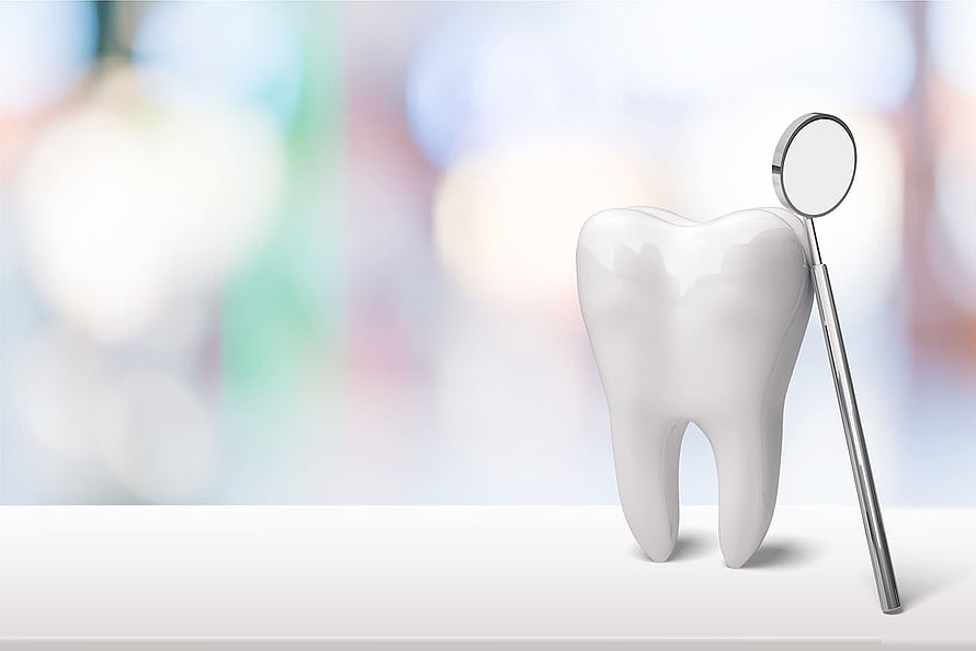 White Tooth Model with Dental Mirror on a Clean White Surface HD wallpaper