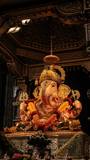 Ornate Ganesha Murti Adorned With Marigold Garlands In A Temple Shrine HD phone wallpaper