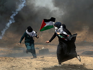 Palestinian Protesters Running Through Smoke in Gaza HD wallpaper