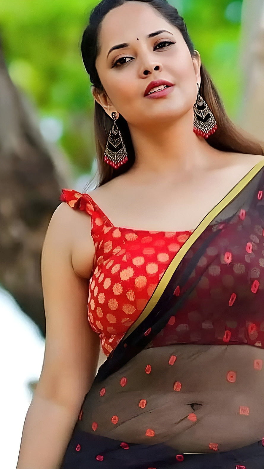 Anusuya Bharadwaj in a red and black polka dot saree with gold border and traditional jhumka earrings HD phone wallpaper