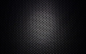 Dark Hexagonal Metal Mesh with Central Spotlight and Industrial Texture HD wallpaper