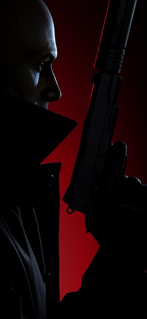 Hitman 3 Agent 47 Profile with Suppressed Pistol Against Deep Red Background HD phone wallpaper