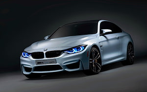BMW M4 F82 Coupe with Iconic Blue LED Headlights in Studio Setting HD wallpaper