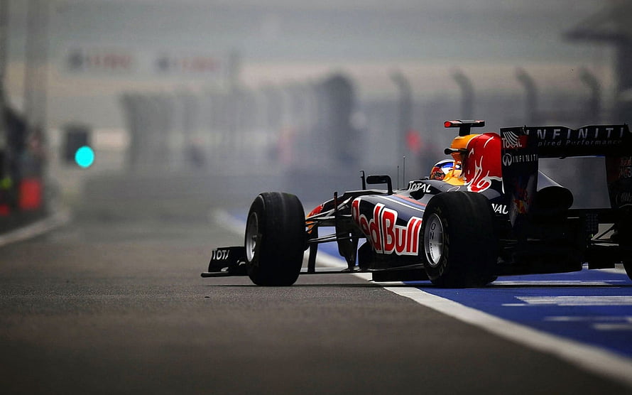 Red Bull Racing Formula 1 car speeding on a misty race track with Infiniti sponsorship HD wallpaper