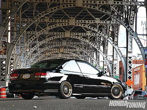 Black Honda Civic Coupe with Gold Mesh Wheels Under Steel Bridge Arch HD wallpaper