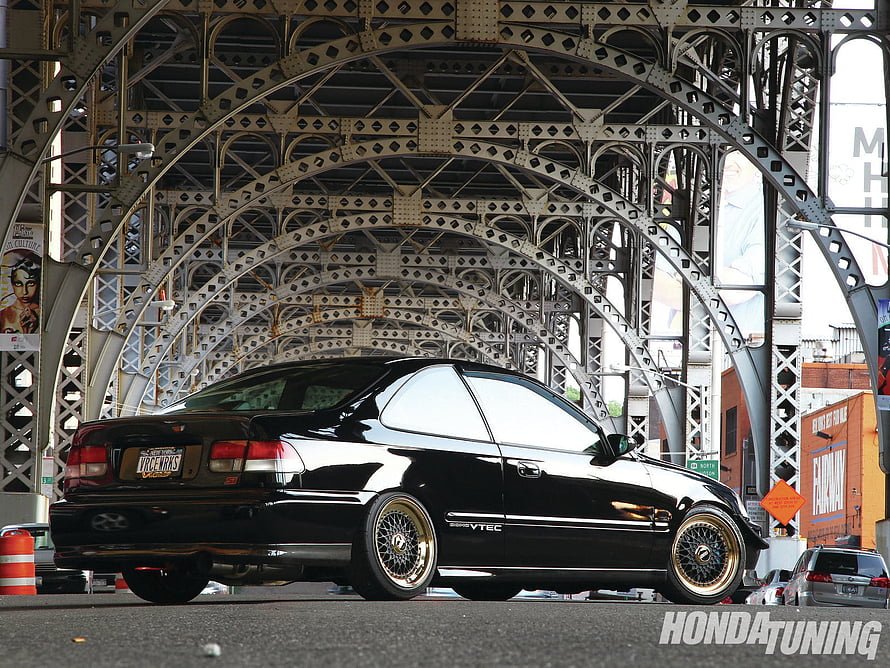 Black Honda Civic Coupe with Gold Mesh Wheels Under Steel Bridge Arch HD wallpaper