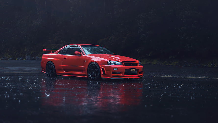 Red Nissan Skyline GT-R R34 Coupe Parked on Wet Asphalt in Rainy Night Setting HD wallpaper