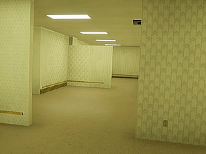 The Backrooms: Endless Yellow Office Corridor with Patterned Walls and Fluorescent Lighting HD wallpaper