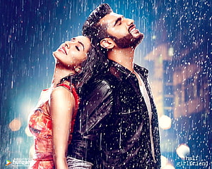 Bollywood Romantic Couple Embracing in the Rain with City Lights HD wallpaper
