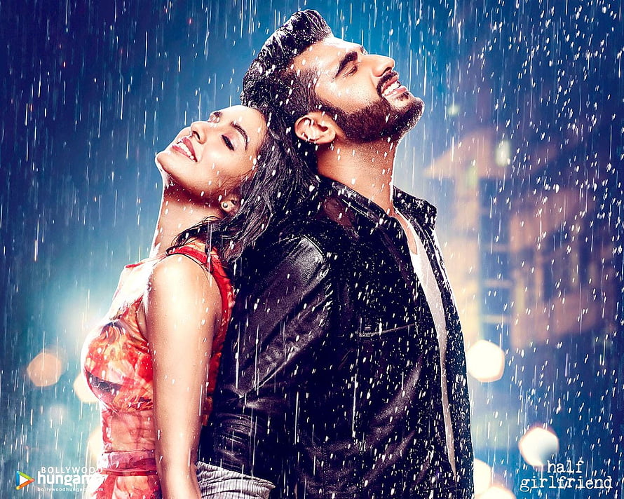 Bollywood Romantic Couple Embracing in the Rain with City Lights HD wallpaper