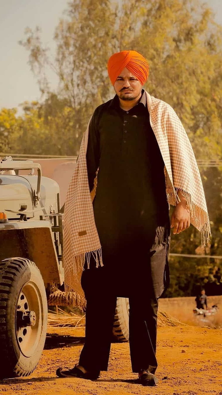 Sidhu Moose Wala in Traditional Punjabi Attire Standing in a Rural Village Setting HD phone wallpaper